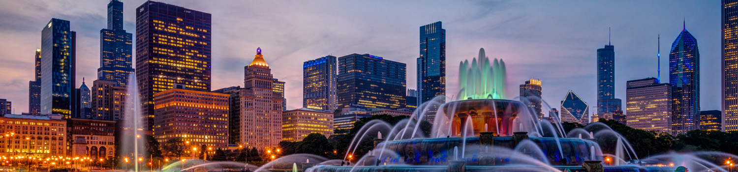 Buckingham fountain shot with a slow shutter speed to capture the colorful light changes and illuminated Chicago skyline in the background.